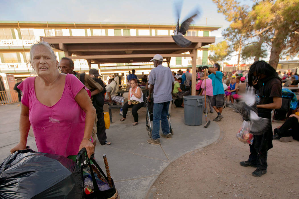 Wanda Johnson, 64, waits in line for disabled residents seeking to sleep on outside mattresses ...