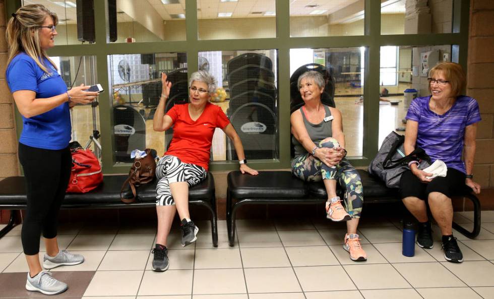 Anita Stephens, left, a SilverSneakers fitness instructor, talks to, from second from left, Ton ...