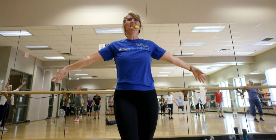 Anita Stephens leads a STRONG by Zumba class as part of the SilverSneakers fitness program at D ...