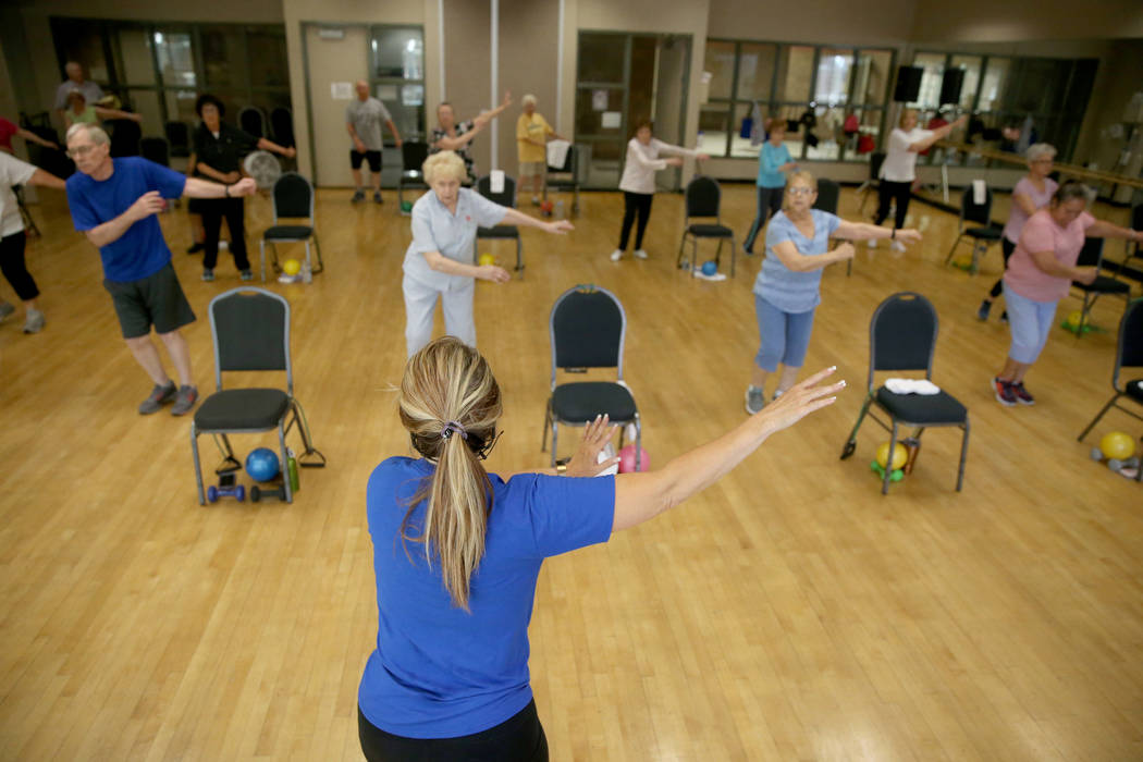 Anita Stephens teaches a Body Flow class as part of the SilverSneakers fitness program at Duran ...