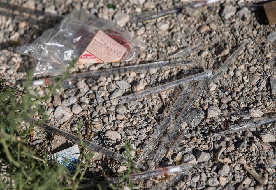 Unused syringes are mixed in with other trash near the intersection of West Charleston Boulevar ...