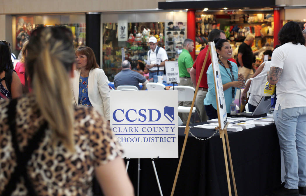 Individuals visit different booths during the annual Cox Back to School Fair at the Galleria at ...