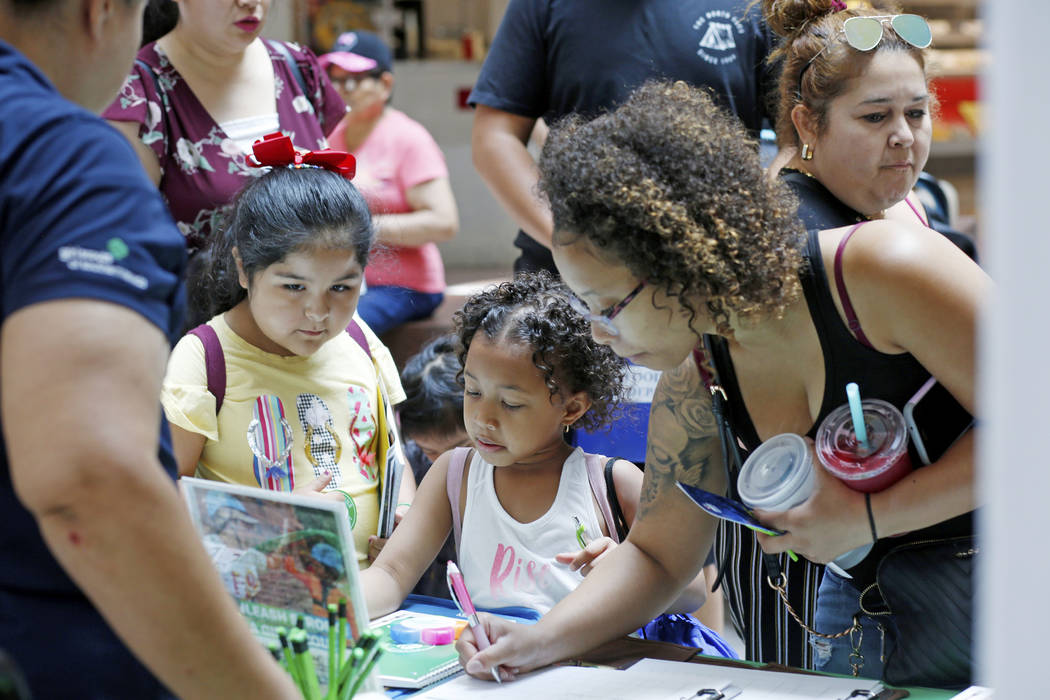 Families and students stop at the Girl Scout booth during the annual Cox Back to School Fair at ...