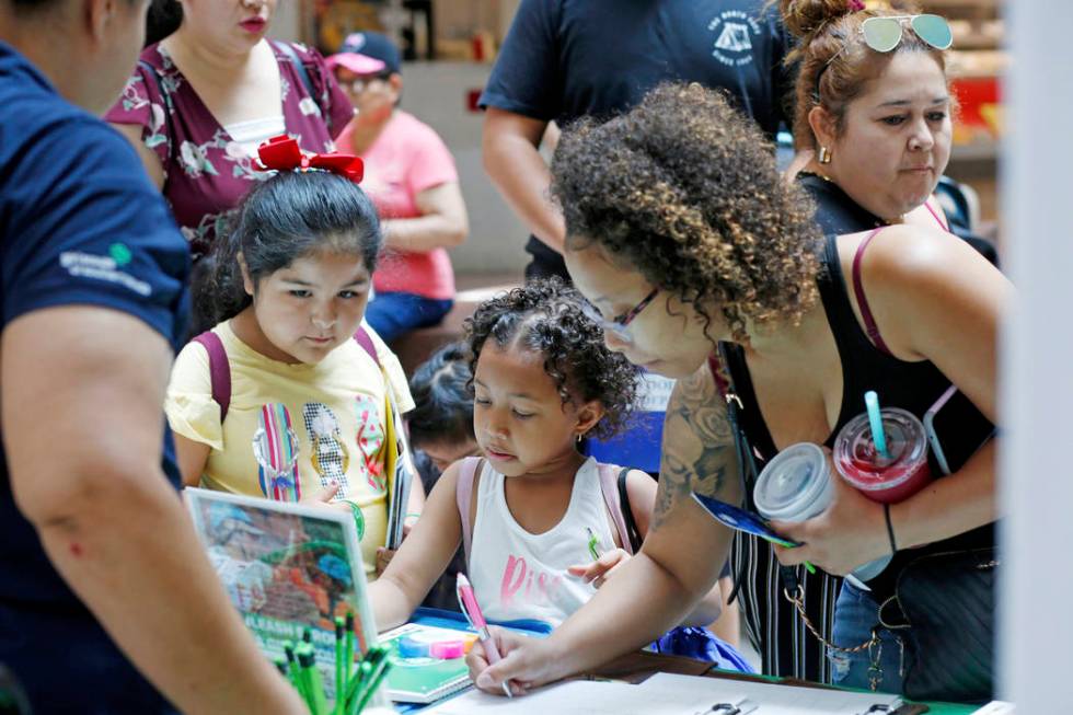 Families and students stop at the Girl Scout booth during the annual Cox Back to School Fair at ...