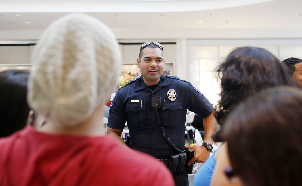 Clark County School District police officer Bernardo Abarca speaks with new CCSD students durin ...