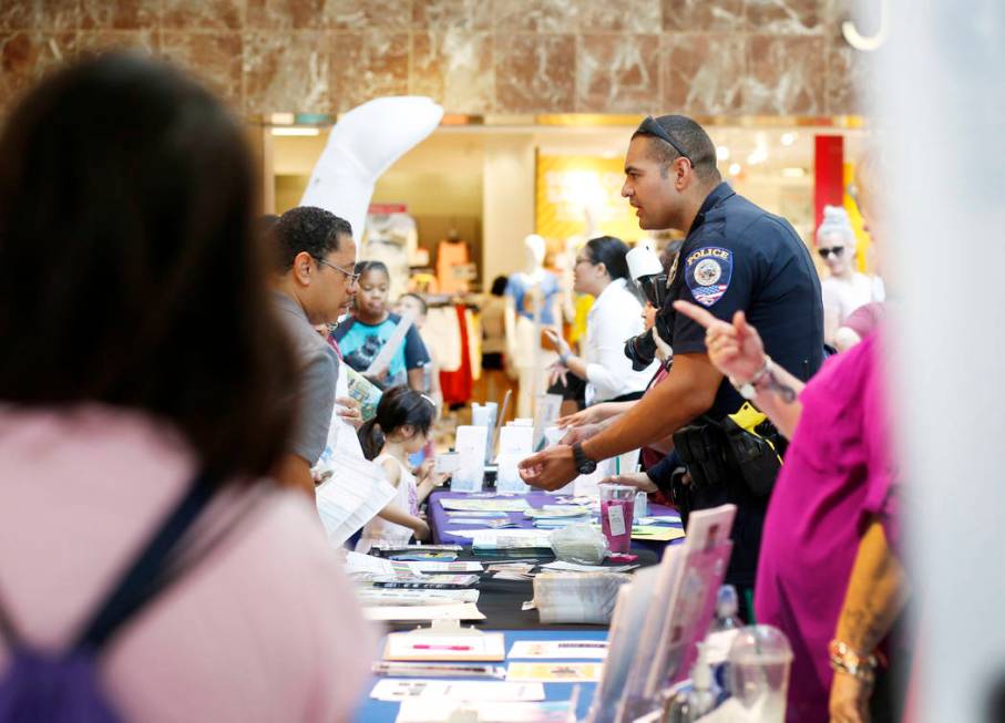 Individuals visit booths during the annual Cox Back to School Fair at the Galleria at Sunset ma ...