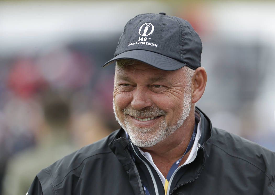 Northern Ireland's Darren Clarke smiles as he speaks to colleagues don the practice range ahead ...