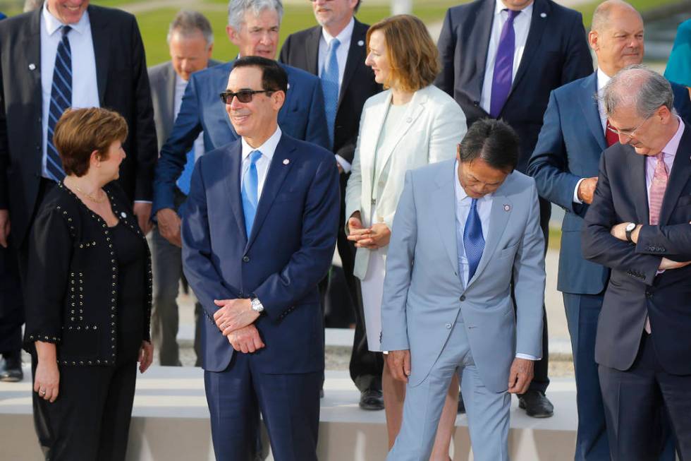 US Treasury Secretary Steve Mnuchin, second left, talks to Chief Executive of the World Bank Kr ...