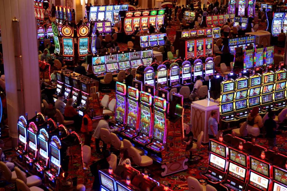 Some of the first guests gamble on the casino floor during the opening of the $2.6 billion Enco ...