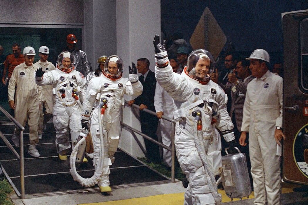 Neil Armstrong, Michael Collins and Buzz Aldrin walk to the van that will take the crew to the ...