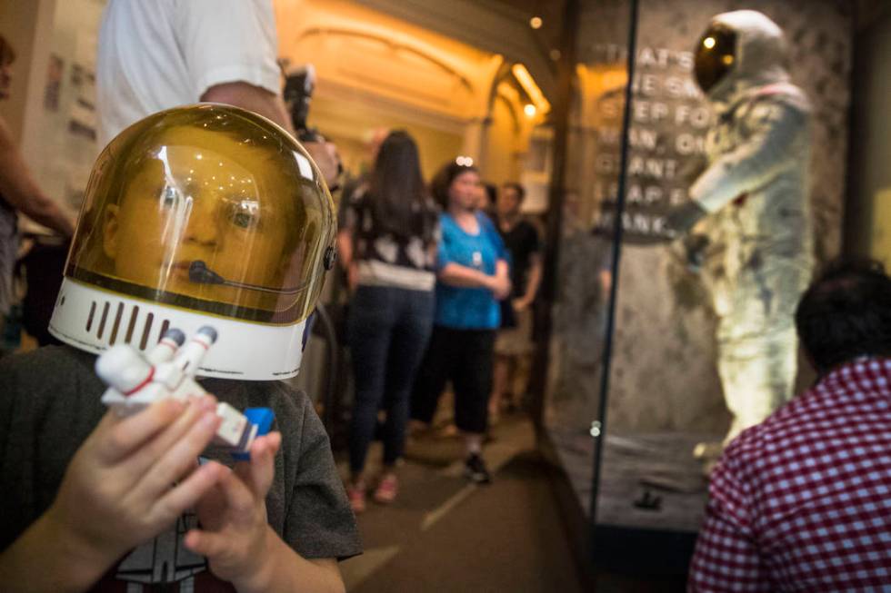 Jack Heely, 5, of Alexandria, Va., wears a toy space helmet as he arrives as one of the first v ...