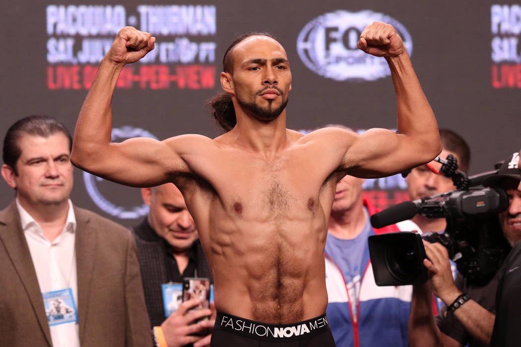 Keith Thurman flexes on the scale during the official weigh-in at the MGM Grand Garden Arena in ...