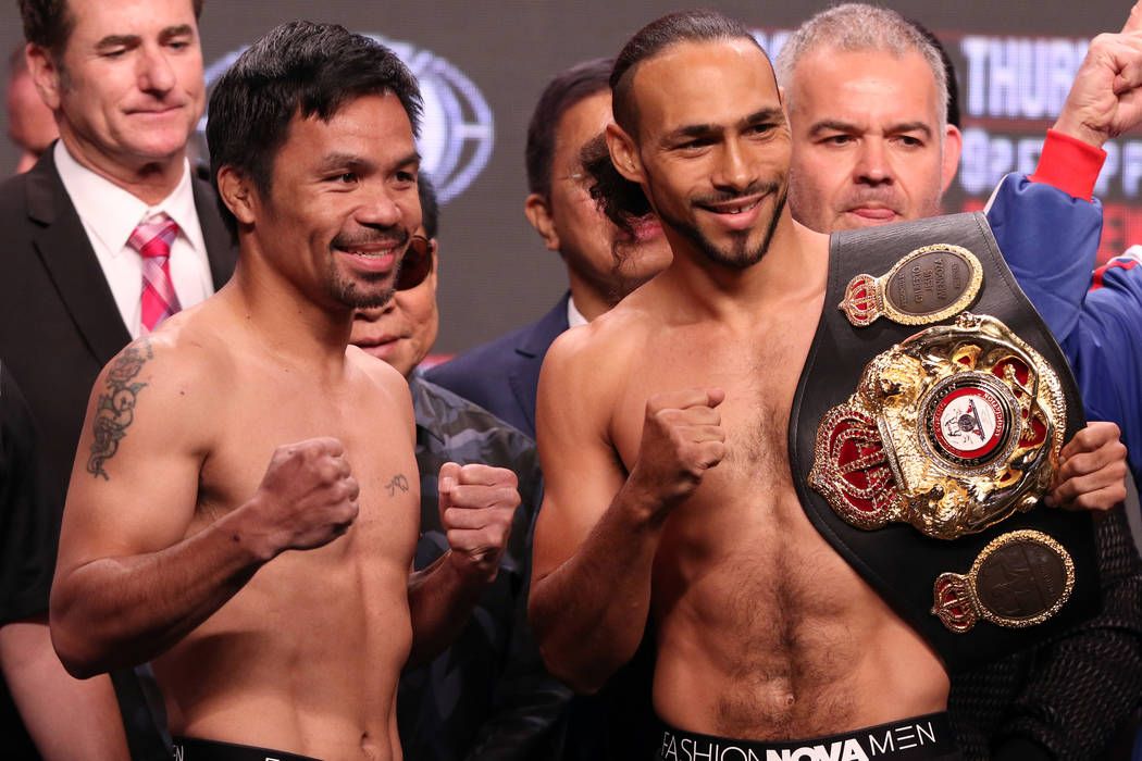 Manny Pacquiao, left, squares off with Keith Thurman during the official weigh-in at the MGM Gr ...