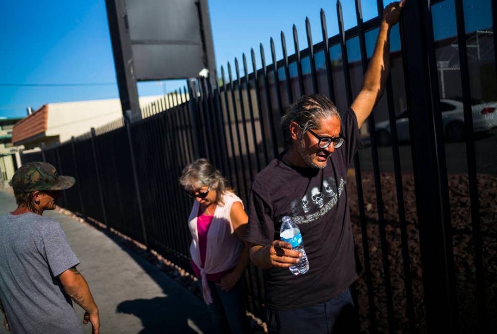 Brian Diaz, right, talks about living homeless while waiting in line for food on Foremaster Lan ...