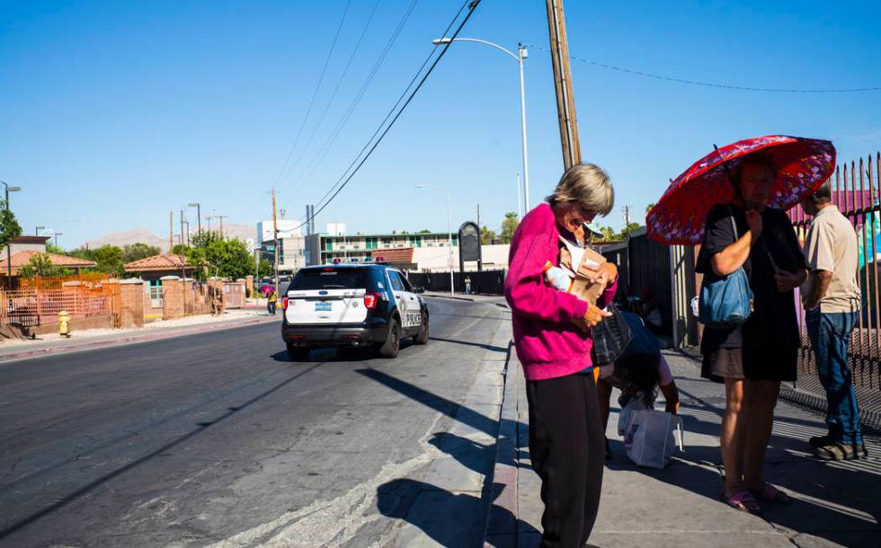 A Las Vegas police car passes by homeless people on Foremaster Lane near downtown Las Vegas on ...