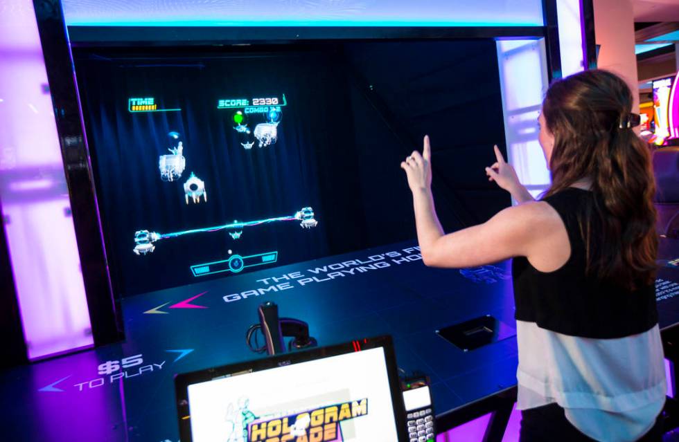 Ashley Crowder, CEO and co-founder of VNTANA, plays a gesture-controlled holographic game as a ...