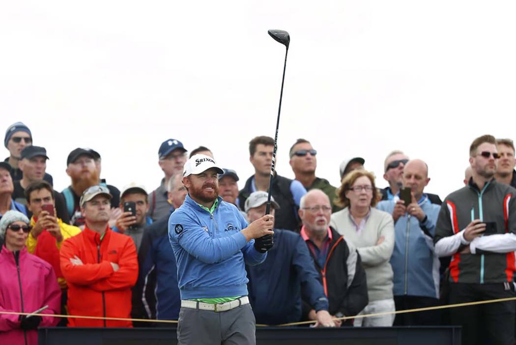 J.B. Holmes of the United States lines up his tee shot on the 14th during the second round of t ...