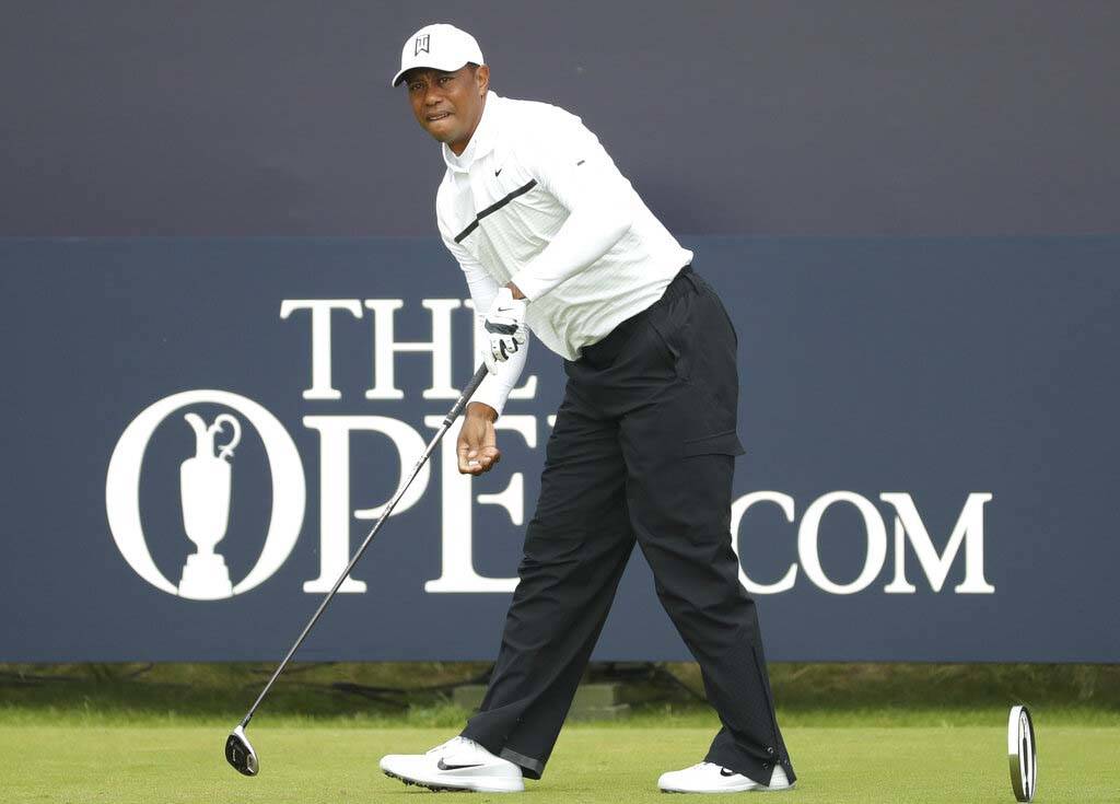 Tiger Woods of the United States watches his ball after playing off the 1st tee during the seco ...