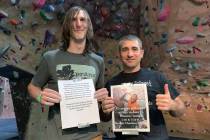 Nevada Climbing Center manager Ryan Lawrence, left, and volunteer Dave Campbell, right, hold up ...