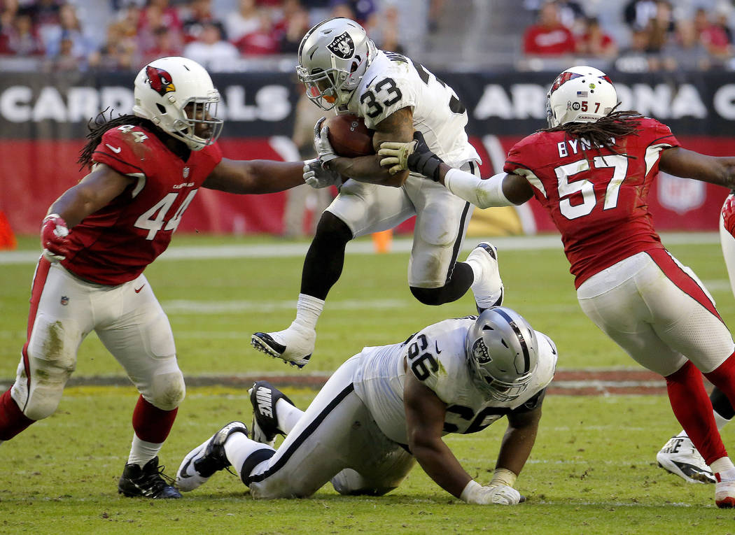 Oakland Raiders running back DeAndre Washington (33) runs as Arizona Cardinals middle linebacke ...