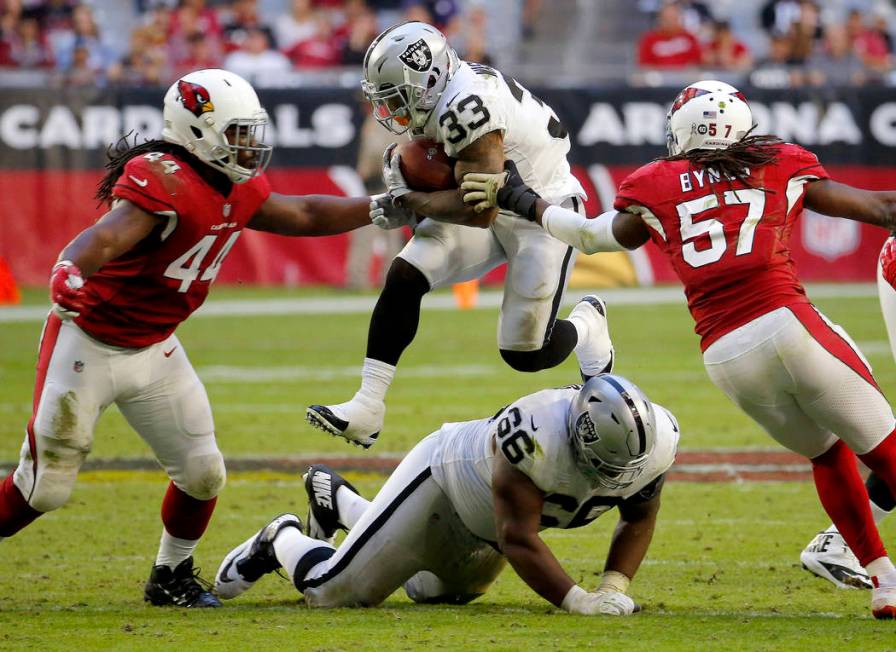 Oakland Raiders running back DeAndre Washington (33) runs as Arizona Cardinals middle linebacke ...