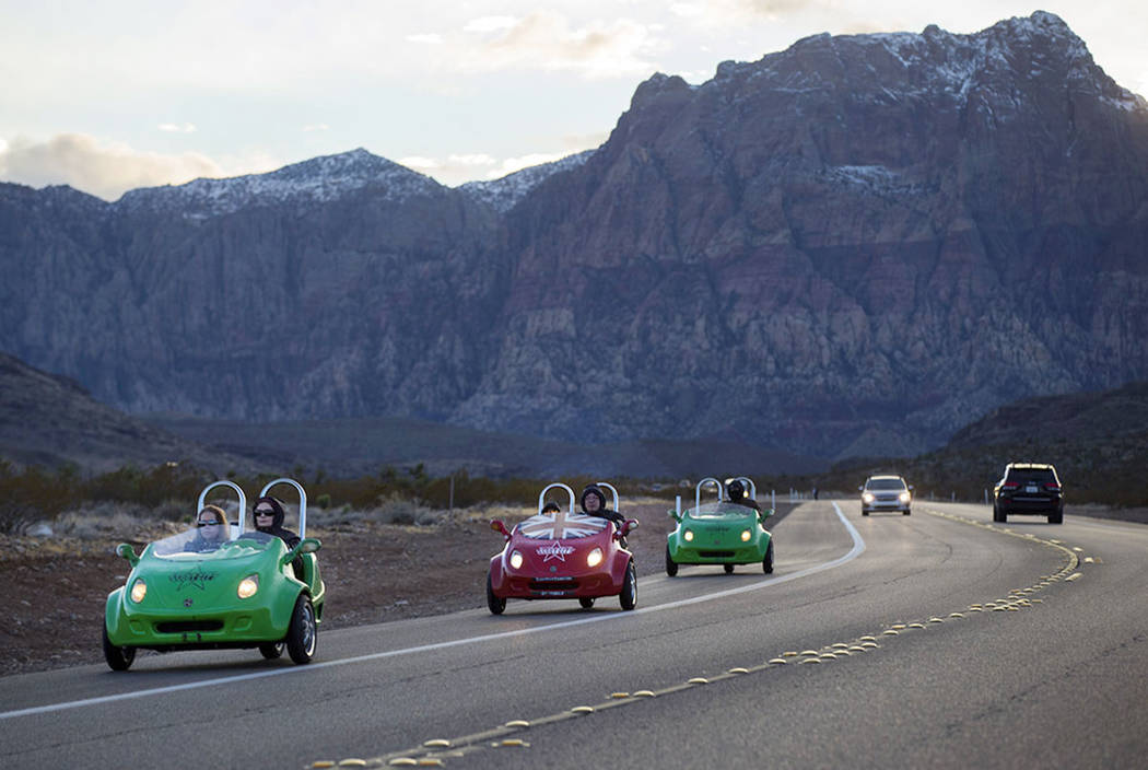 Scooter cars pass through the Red Rock Canyon National Conservation Area outside of Las Vegas o ...