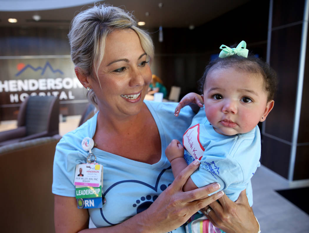 Neonatal Intensive Care Unit Manager Julie Miller holds JudithKaye Montgomery, 6 months, during ...