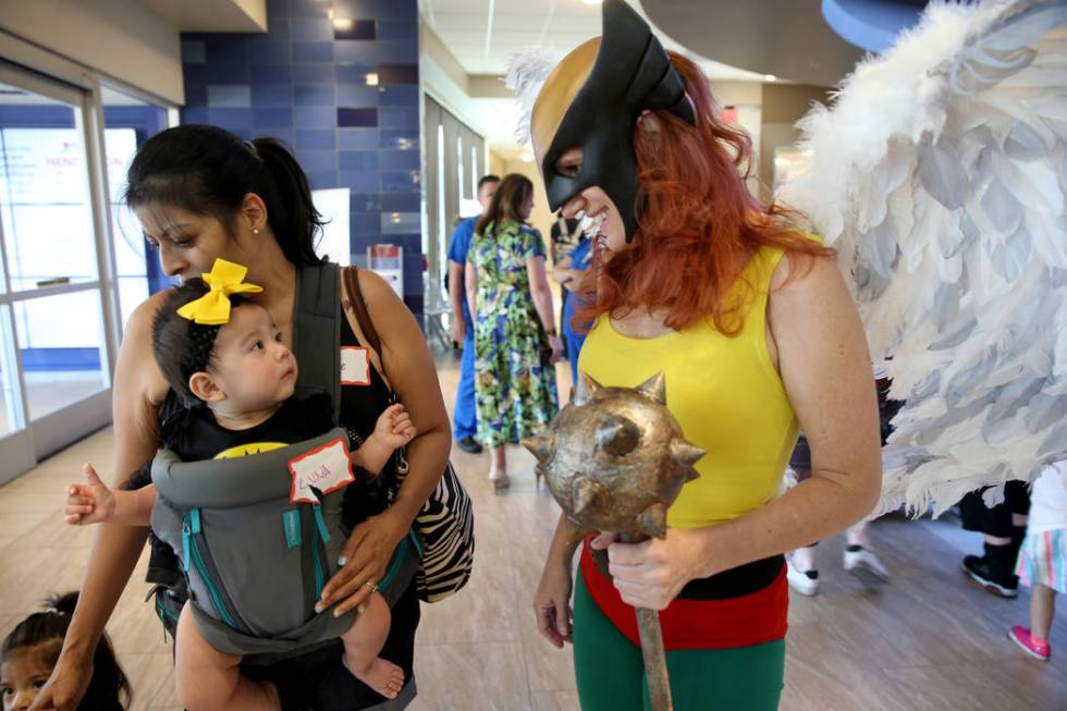 Marry Ann Nocie as Hawkgirl greets Luna Rivas, 3 months, and her mother Evie Rivas during the f ...