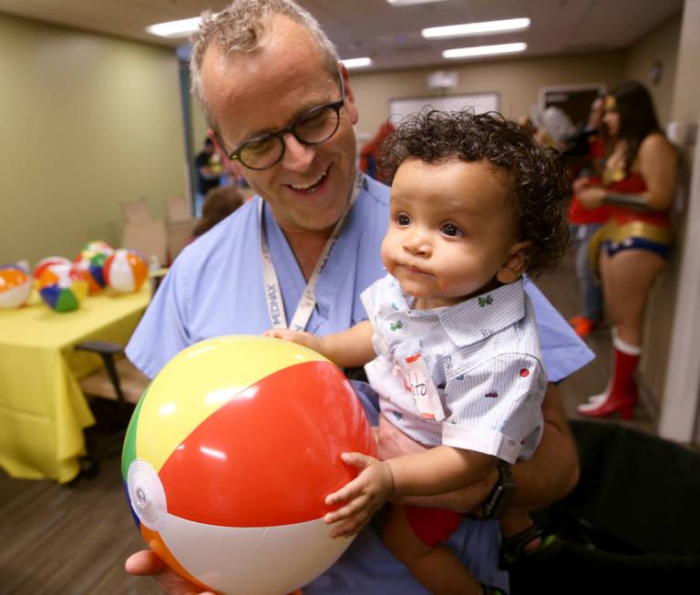 Dr. Phil Vaughn greets Ashton King Daniels, 7 months, during the first-ever Neonatal Intensive ...