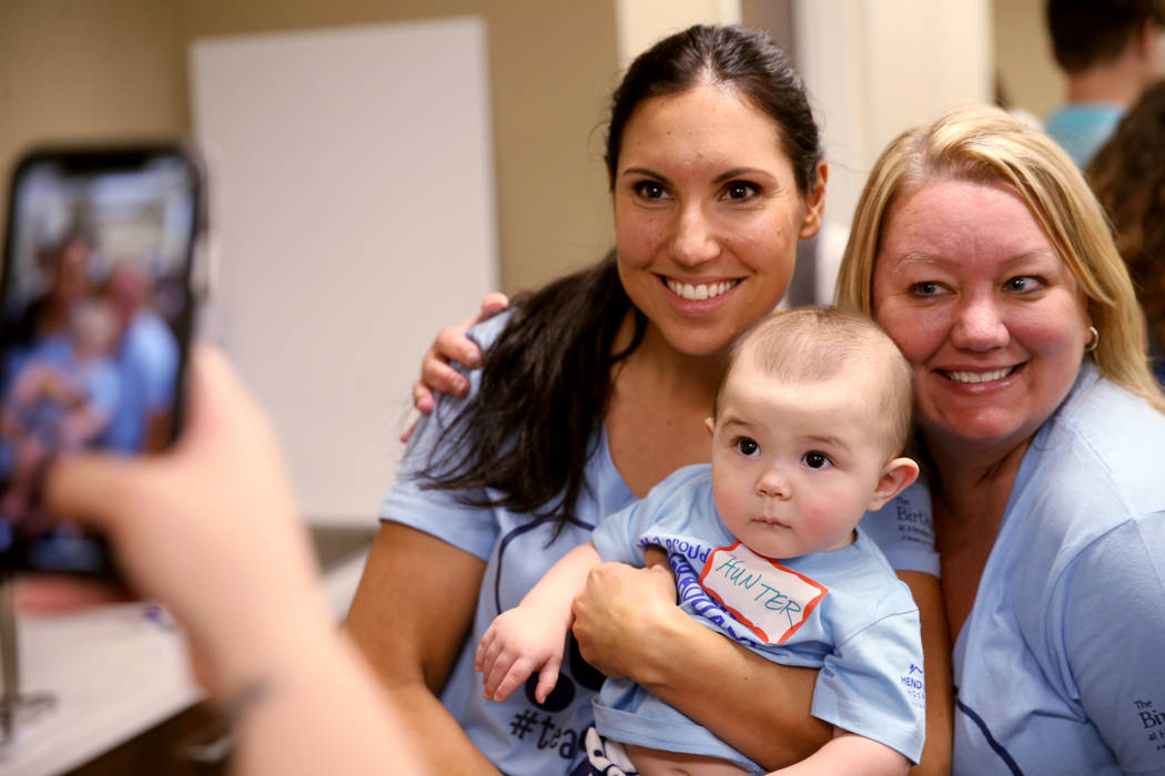 Occupational Therapist Chris Gutierrez, right, and Physical Therapist Kristen Groot pose with H ...