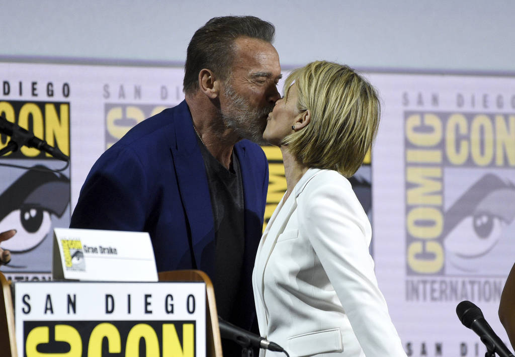 Arnold Schwarzenegger, left, and Linda Hamilton kiss at the "Terminator: Dark Fate" p ...