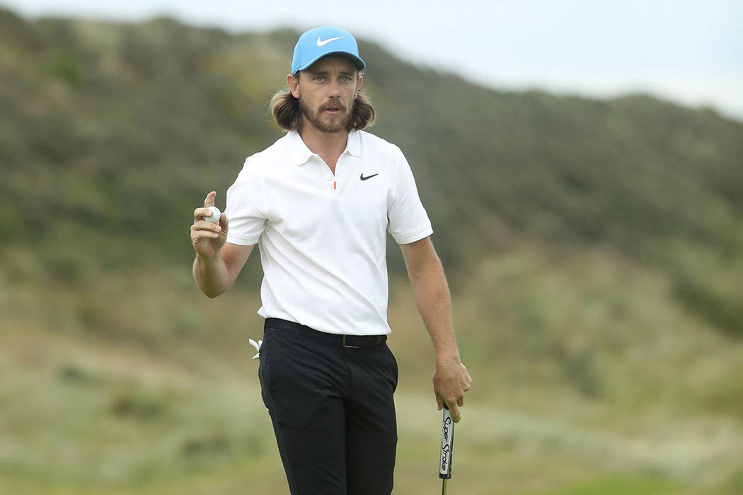 England's Tommy Fleetwood reacts after he saves parr on the 15th green during the third round o ...