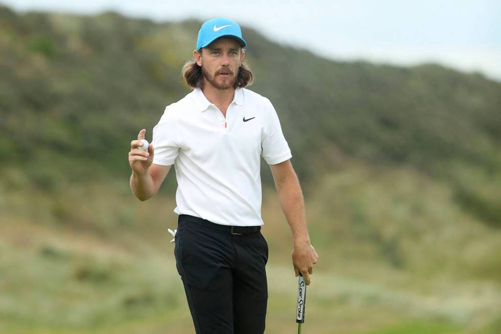 England's Tommy Fleetwood reacts after he saves parr on the 15th green during the third round o ...