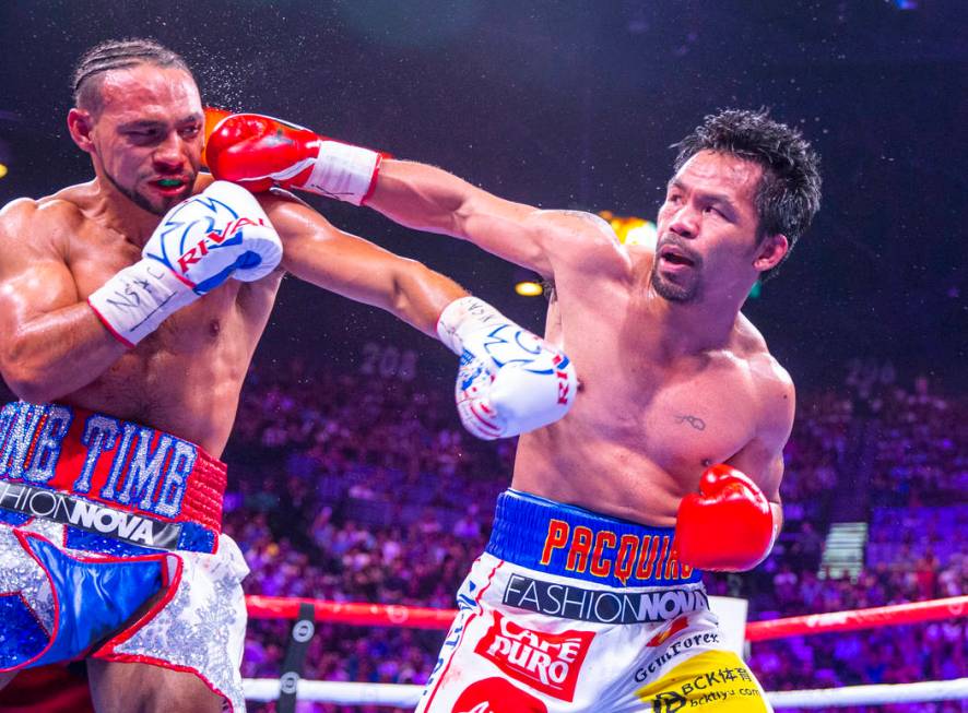 Keith Thurman is punches in the face by Manny Pacquiao during Round 5 of their WBA super welter ...