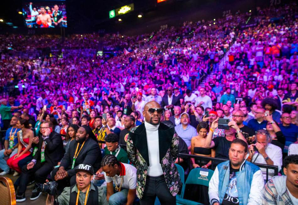 Former boxer Floyd Mayweather Jr. watches as Manny Pacquiao and Keith Thurman enter the ring du ...