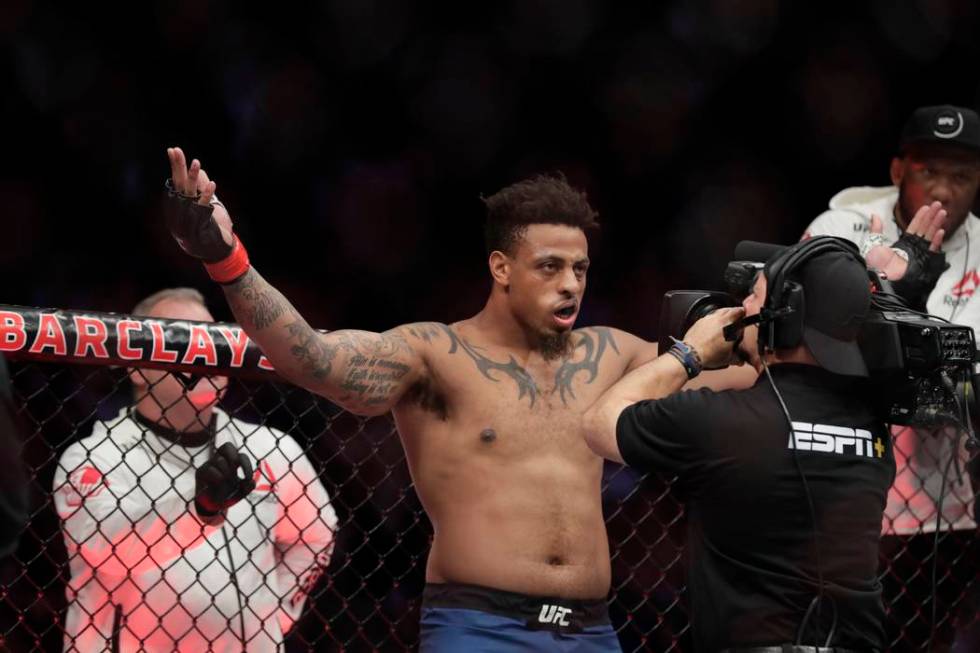 Greg Hardy reacts as he is announced for a heavyweight mixed martial arts bout against Allen Cr ...