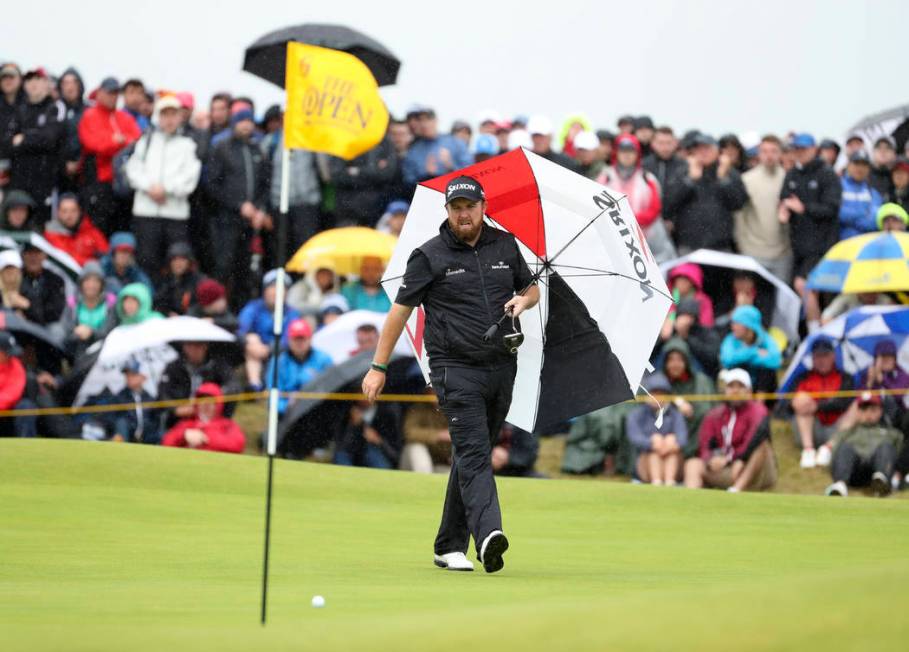 Ireland's Shane Lowry walks with his umbrella on the 6th green during the final round of the Br ...