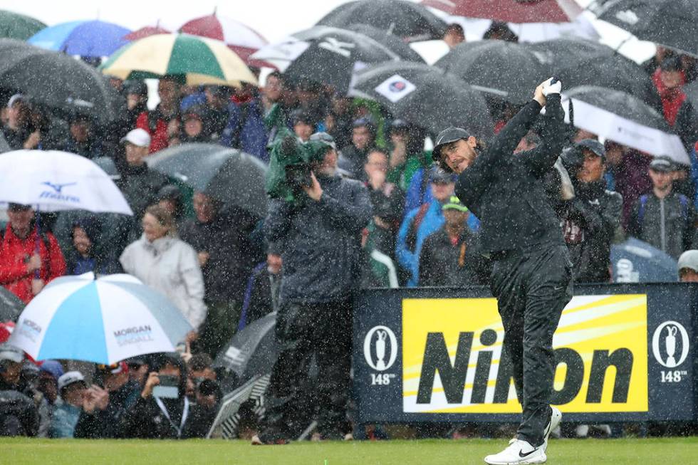 England's Tommy Fleetwood tees off the 9th tee hole in heavy rain during the final round of the ...