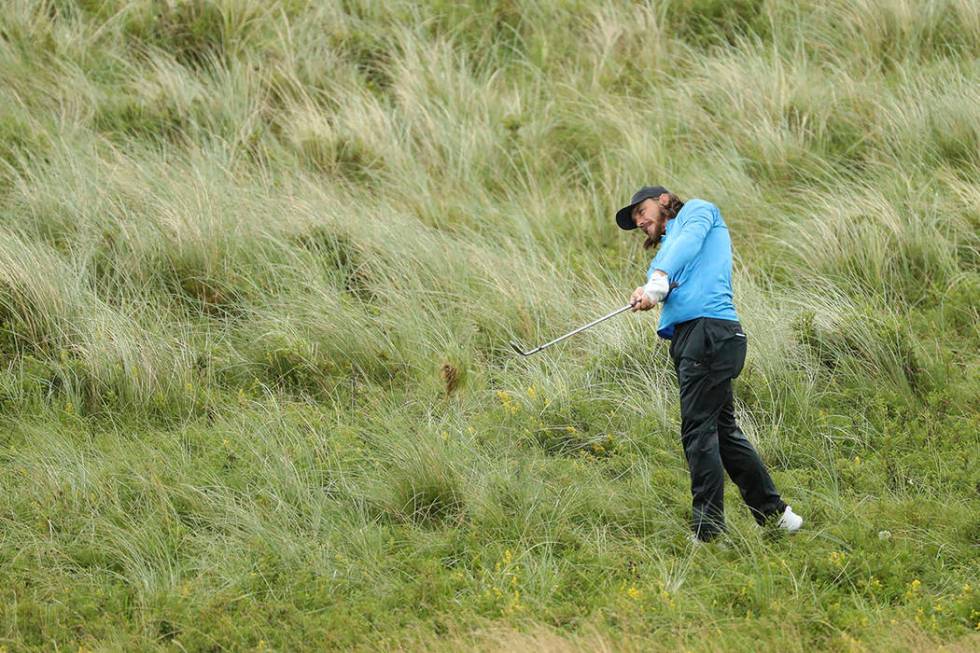 England's Tommy Fleetwood plays from the rough on the 7th hole during the final round of the Br ...