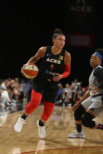 Las Vegas Aces guard Kayla McBride (21) dribbles to the hoop against Minnesota Lynx guard Odyss ...