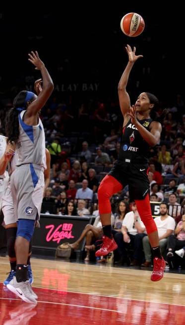 Las Vegas Aces guard Sydney Colson, right, attempts a layup against Minnesota Lynx forward Asia ...