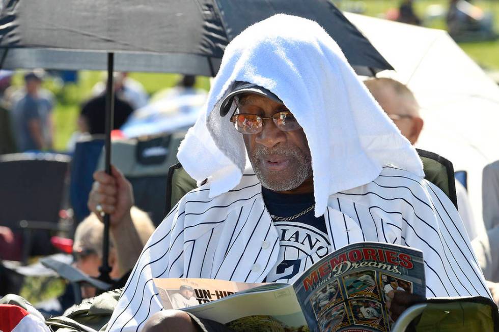 Mariano Rivera fan Eugenino Edwards, of New York uses a towel to keep cool before the National ...