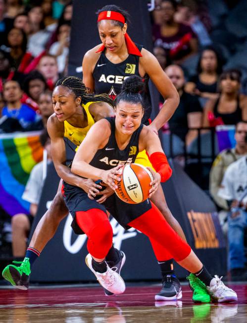 Las Vegas Aces guard Kayla McBride (21) is fouled from behind on a fast break attempt by Indian ...
