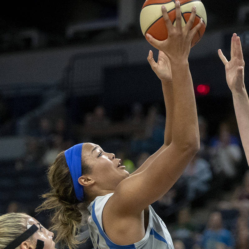 Minnesota Lynx Napheesa Collier goes up to the basket for two defended by Mystics' Elena Delle ...