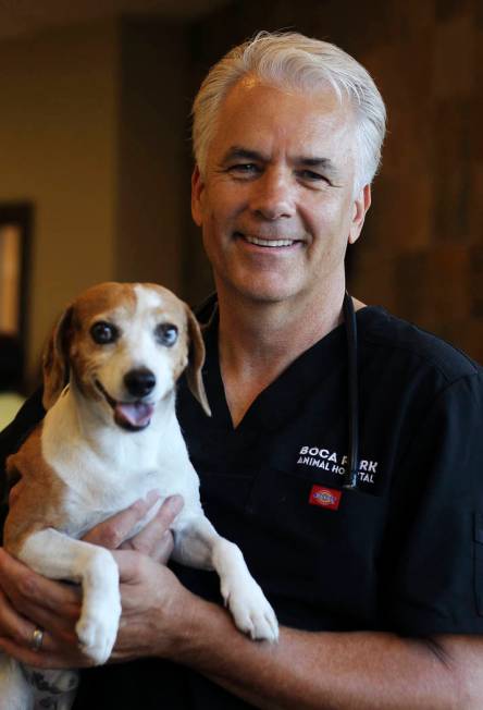 Dr. John Ensign poses for a portrait with his dog Jerome as he prepares to open his new Boca Pa ...