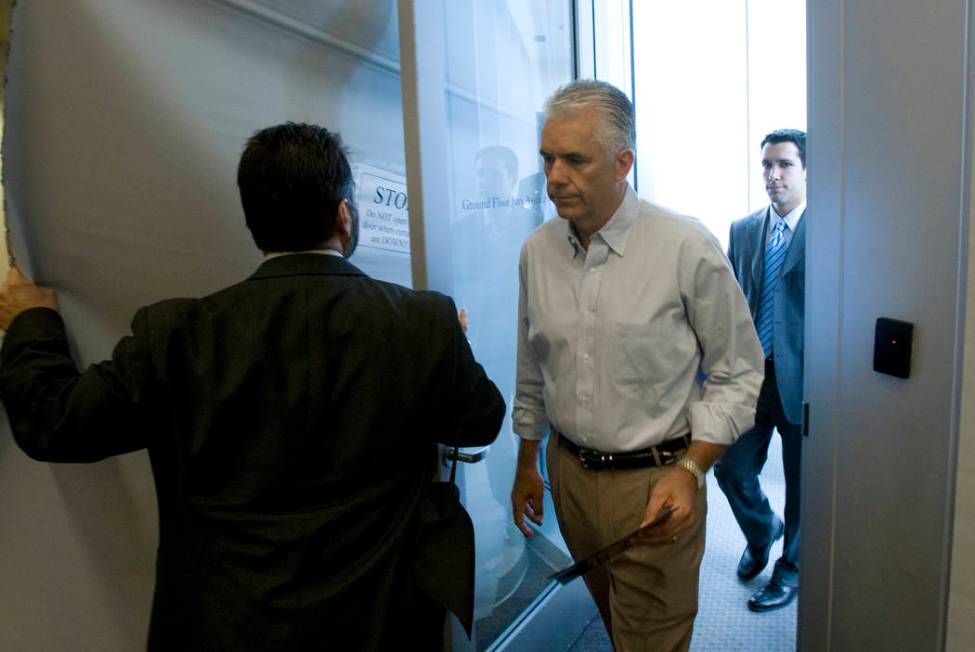 Sen. John Ensign, R-Nev., enters through a side door at the Lloyd George U.S. Courthouse in Las ...