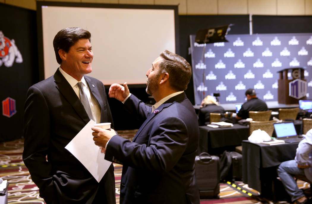 Mountain West commissioner Craig Thompson visits with Las Vegas Bowl Executive Director John Sa ...