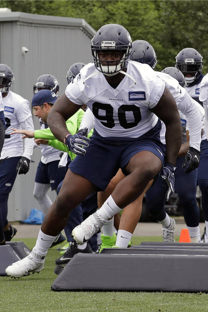 FILE - In this May 24, 2018, file photo, from left, Seattle Seahawks defensive tackle Jarran Re ...