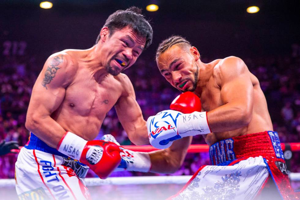 Manny Pacquiao punches Keith Thurman during Round 1 of their WBA super welterweight world champ ...