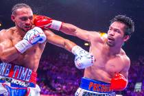 Keith Thurman is punched in the face by Manny Pacquiao during Round 5 of their WBA super welter ...